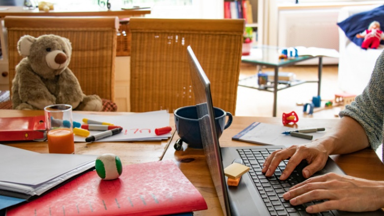 Das Bukd zeigt einen Homeoffice-Esstisch mit Laptop und Teddybär